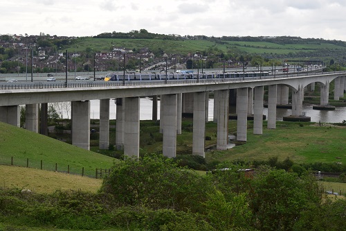 A High Speed train passes over the River Medway viaduct