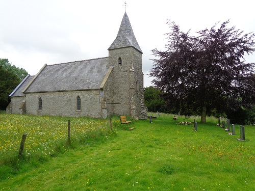 The bench and front of St. Mary's Church in Newchurch