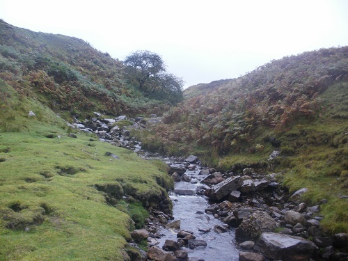 A small stream passing down and under the high route track