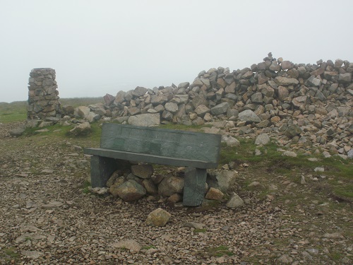 The summit of High Pike with an inviting slate bench