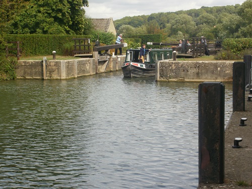 A narrowboat passes through a Lock on the River Thames
